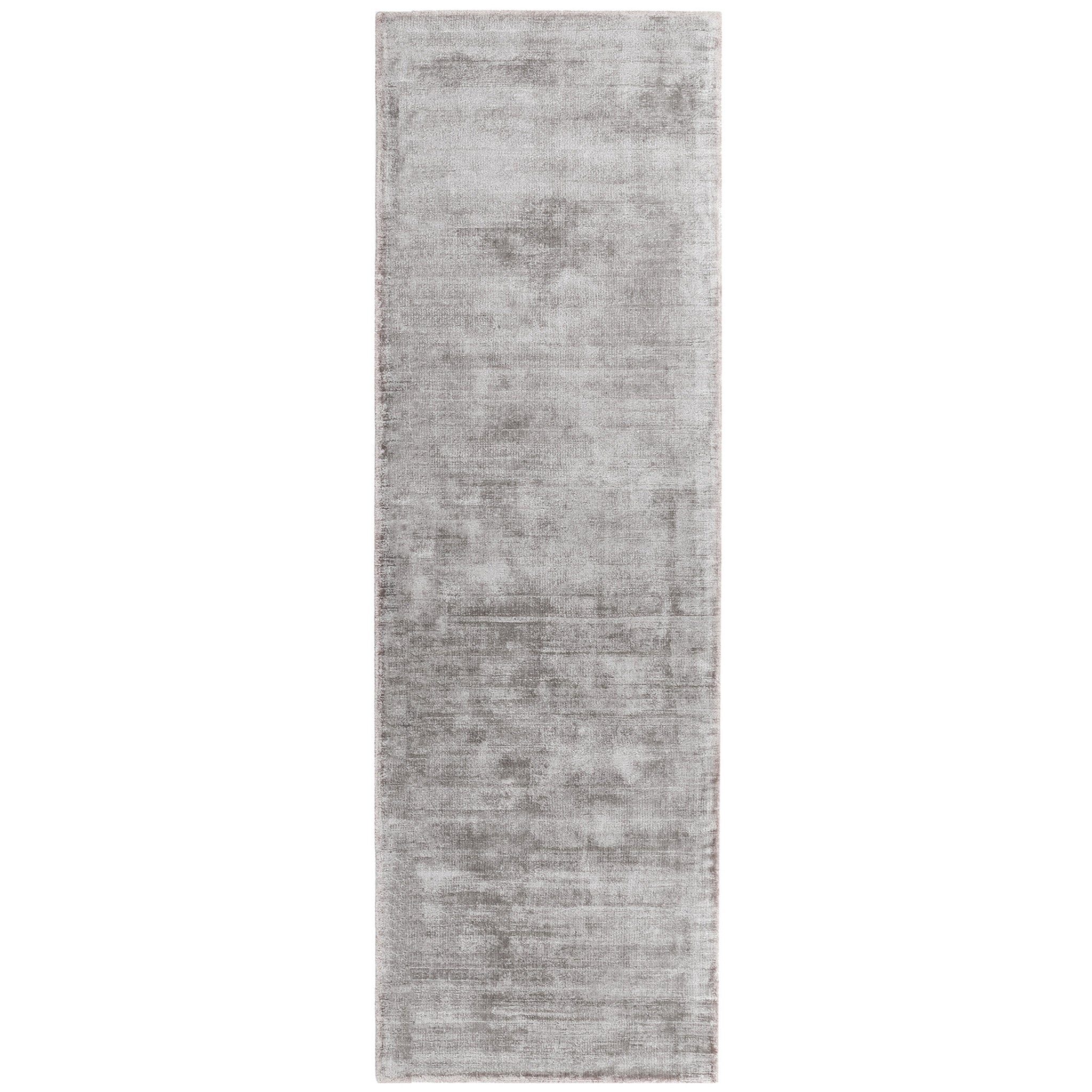 Luxury handwoven viscose rug, in silver colour, with a tip sheared finish giving a vintage effect. Size - Runner Pile Height: 7mm Dimensions: 660 x 2400 mm 100% Viscose Hand Woven in India Delivery: 5-7 days